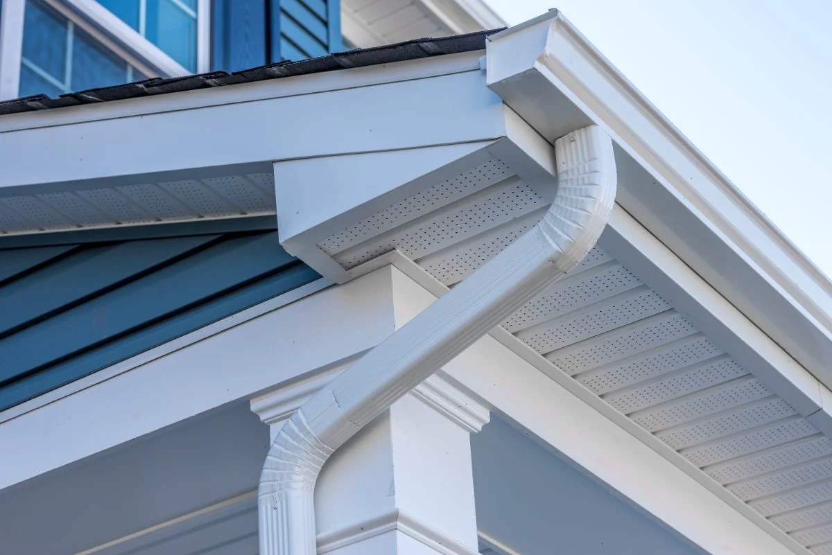 K-style seamless gutters with white downspout on home exterior